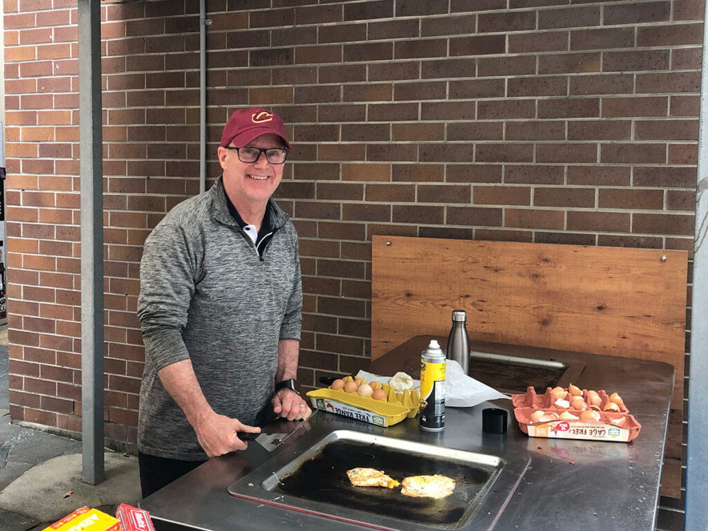Tim Macuga at the grill for the brekky bbqs